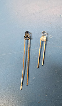 Two small infrared LEDs side by side, bare electronic components.